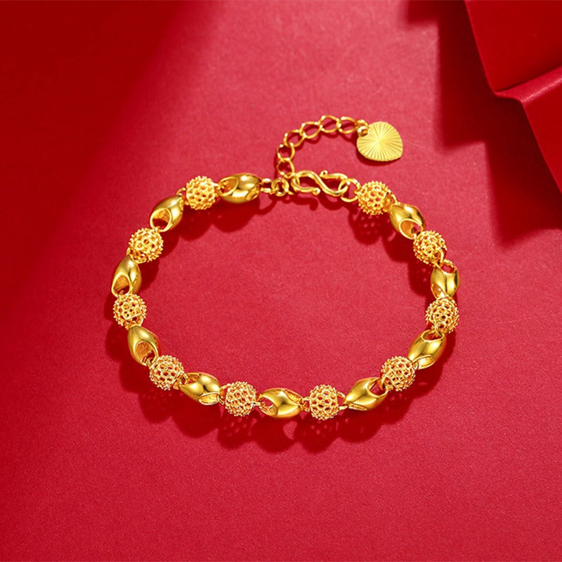 gold bracelet on red background