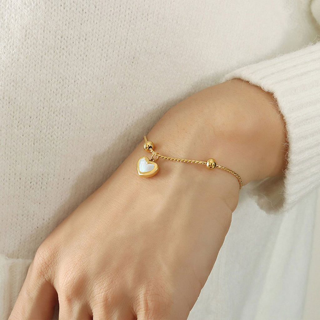 women hands with mother of pearl adjustable bracelet