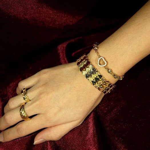 women hands with gold strap bracelet